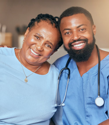 male nurse and elderly woman smiling