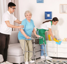 caretaker helps the elderly woman