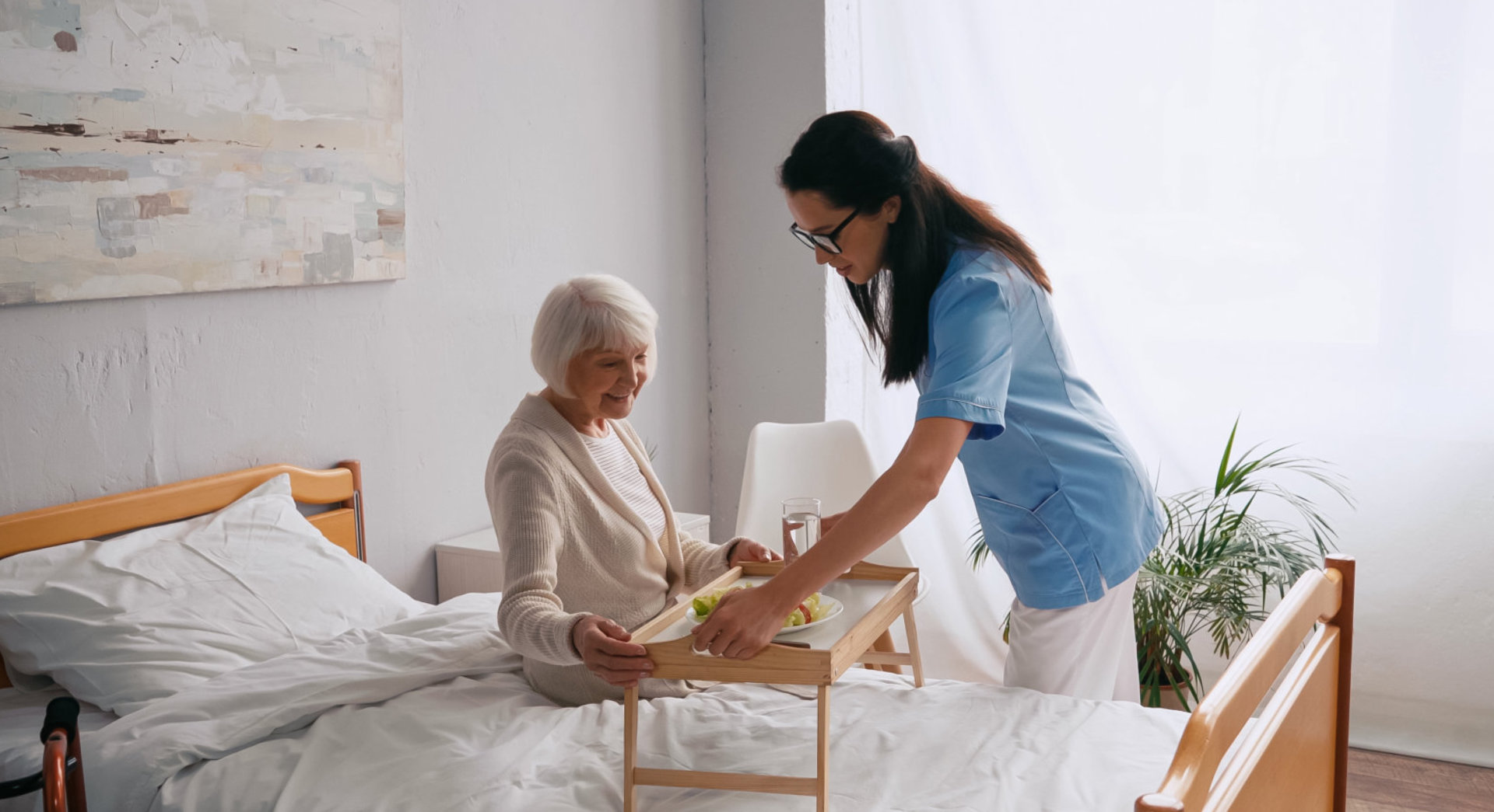 caretaker prepare food for elderly woman