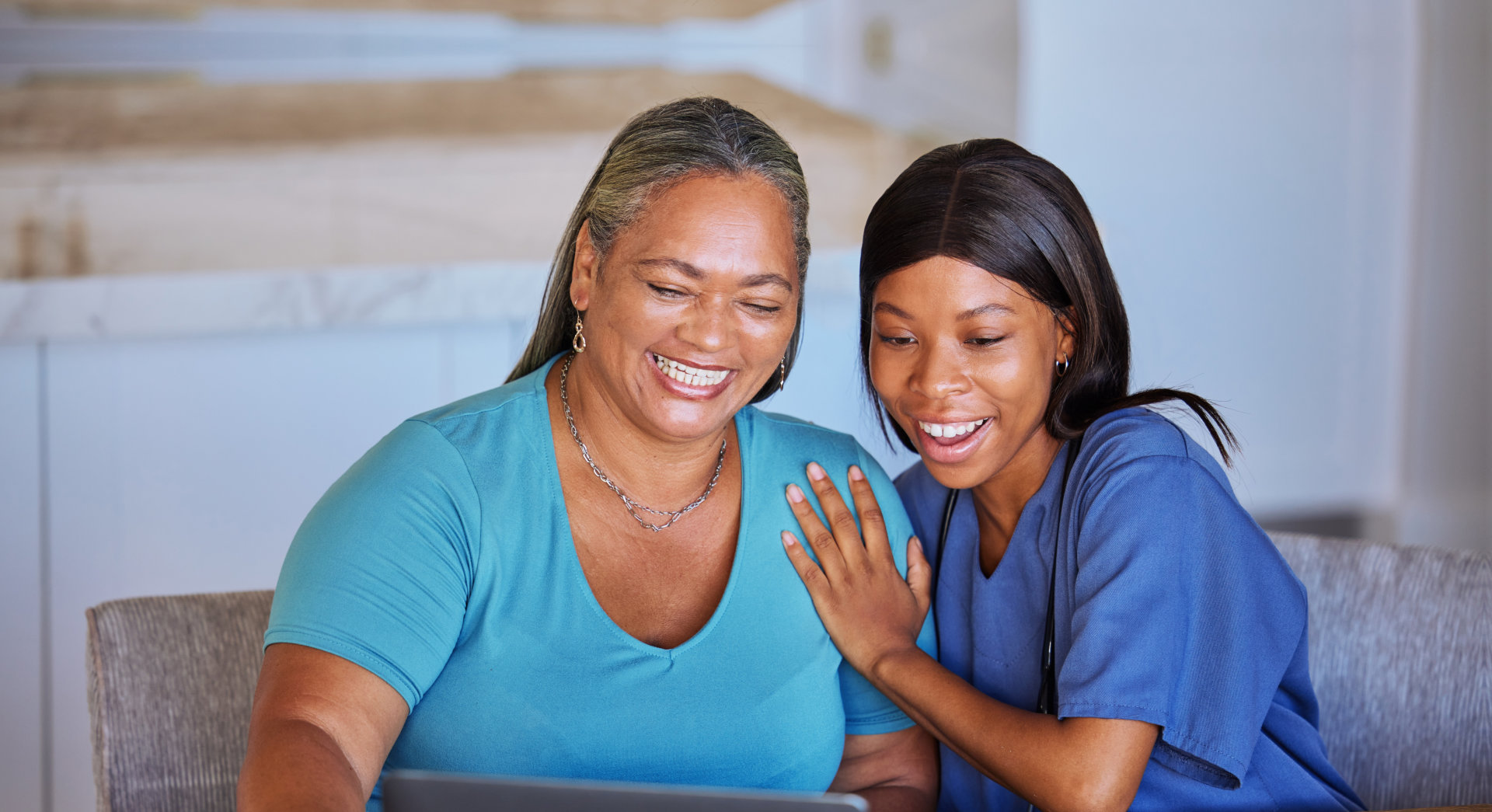 elderly woman and caretaker smiling